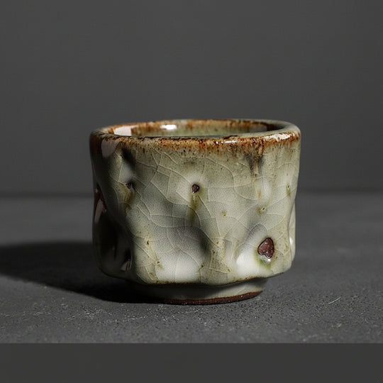 Handmade Jianzhan round tea cup with green-brown tenmoku glaze