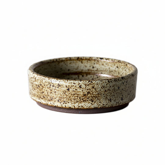 Rough pottery mug with retro glaze showing intentional surface variation