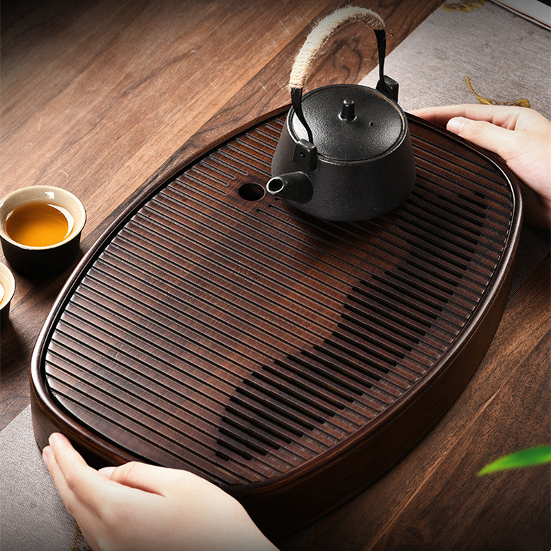 Close-up of bamboo tea tray drainage groove slats showing dark charred finish
